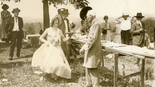 From the original caption, published in 1926: "Major J.L. McCollum, veteran of the Civil War, doffs his hat to Mrs. Warren Vinson, dressed as a girl of the old south, at exercises held by veterans of the Blue and the Gray at Marietta, Ga., June 26, in commemoration of the 62nd anniversary of the Battle of Kennesaw Mountain."
