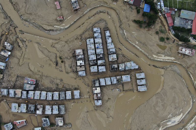 In this aerial image of the Kathmandu valley, a locality is swamped in mud in Kathmandu, Nepal, Monday, Sept. 30, 2024 in the aftermath of a flood caused by heavy rains. (AP Photo/Gopen Rai)