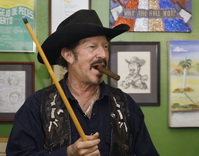 FILE - Texas independent gubernatorial candidate Kinky Friedman is shown at home waiting his turn at the pool table Monday, Nov. 6, 2006, in Austin, Texas. Friedman, the singer, songwriter, satirist and novelist who also dabbled in Texas politics with a campaign for governor, died Thursday at his family’s Texas ranch near San Antonio. He was 79. (AP Photo/Harry Cabluck, File)