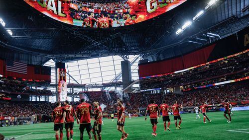 Atlanta United players celebrate with forward Jamal Thiaré (29) after he scored his team’s third goal during the second half against the Chicago Fire at Mercedes-Benz Stadium on Sunday, March 31, 2024.
 Miguel Martinez / miguel.martinezjimenez@ajc.com