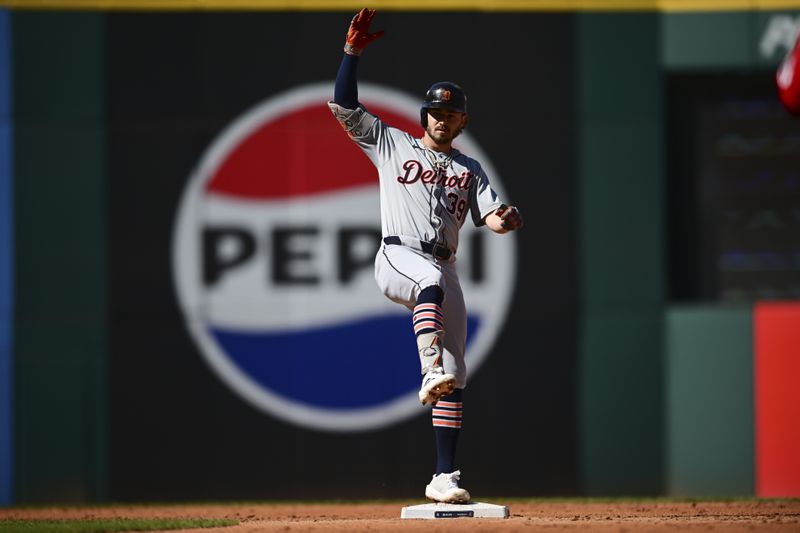 Detroit Tigers' Zach McKinstry celebrates a hitting a double at second base during the second inning of Game 1 of baseball's AL Division Series against the Cleveland Guardians, Saturday, Oct. 5, 2024, in Cleveland. (AP Photo/David Dermer)