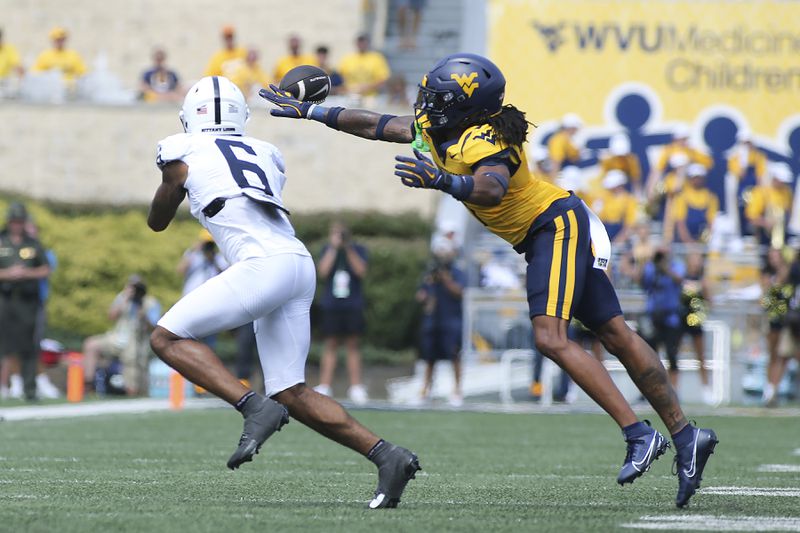 Penn State wide receiver Harrison Wallace III (6) is defended by West Virginia cornerback Garnett Hollis Jr. (1) during the first half of an NCAA college football game in Morgantown, W.Va., Saturday, Aug. 31, 2024. (AP Photo/Kathleen Batten)