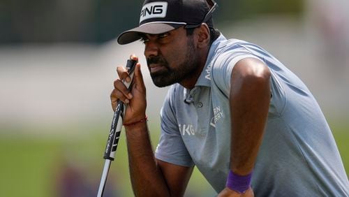 Sahith Theegala lines up his putt on the third green during the final round of the Tour Championship golf tournament, Sunday, Sept. 1, 2024, in Atlanta. (AP Photo/Mike Stewart)