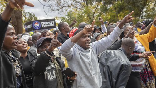 Opposition supporters protest outside a court, in Harare, Zimbabwe, Thursday, June 27, 2024. The protesters were angered by a magistrate's decision to deny bail to close to 80 activists arrested mid-June for allegedly meeting without official clearance. (AP Photo/Aaron Ufumeli)