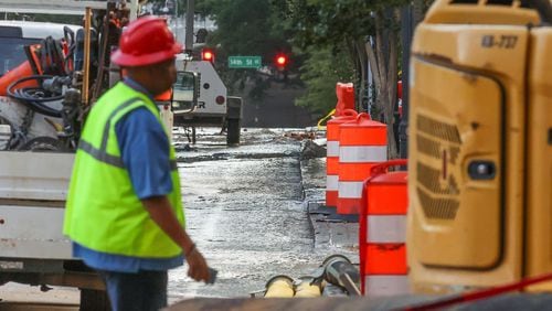 Crews were continuing to repair a broken water main on West Peachtree Street in Midtown on Tuesday morning, June 4, 2024. (John Spink / AJC)