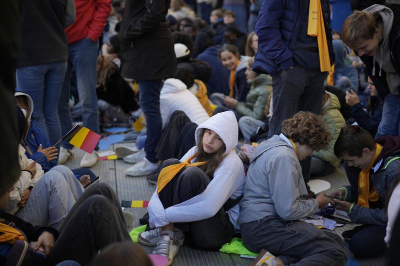 Faithful wait for the start of a mass presided by Pope Francis at King Baudouin Stadium, in Brussels Sunday, Sept. 29, 2024. (AP Photo/Andrew Medichini)