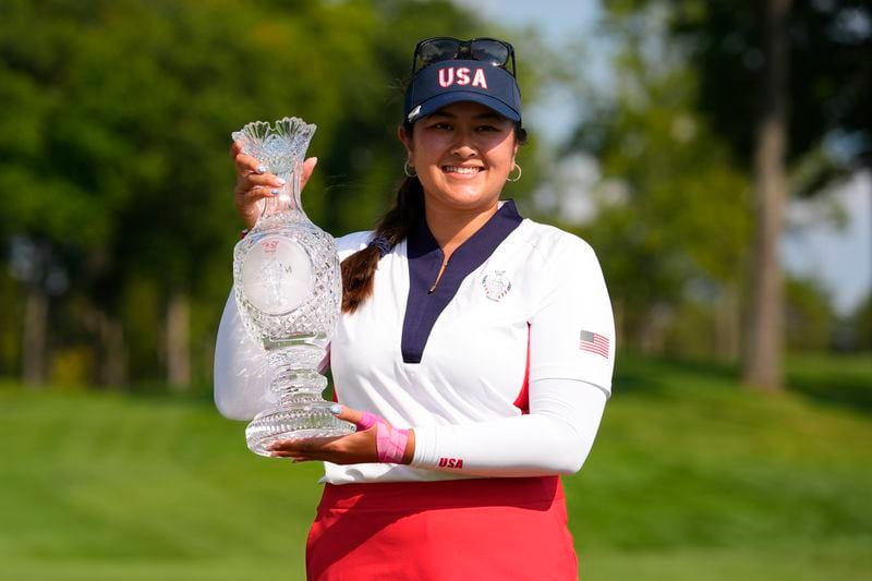 United States' Lilia Vu holds the winner's trophy after the United States defeated Europe in the Solheim Cup golf tournament at the Robert Trent Jones Golf Club, Sunday, Sept. 15, 2024, in Gainesville, Va. (AP Photo/Matt York)