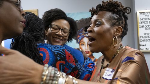 Mayors Sandra Vincent from McDonough, from left, Angelyne Butler from Forest Park, Bianca Motley Broom from College Park and Teresa Thomas Smith from Palmetto greet each other before an event to celebrate Black women mayors in College Park on Wednesday, Feb. 28, 2024. (Ben Gray / Ben@BenGray.com)