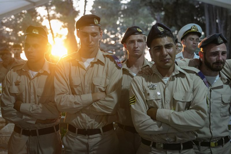 Israeli Navy sailors mourn during the funeral of Petty Officer 1st Class David Moshe Ben Shitrit, who was killed on a Hezbollah attack, at the Mount Herzl military cemetery in Jerusalem, Sunday, Aug. 25, 2024. (AP Photo/Ohad Zwigenberg)