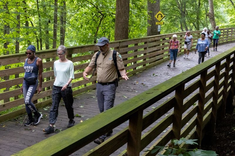 Members of a walking group walk on a trail at Mason Mill park in Decatur. (Arvin Temkar / AJC)