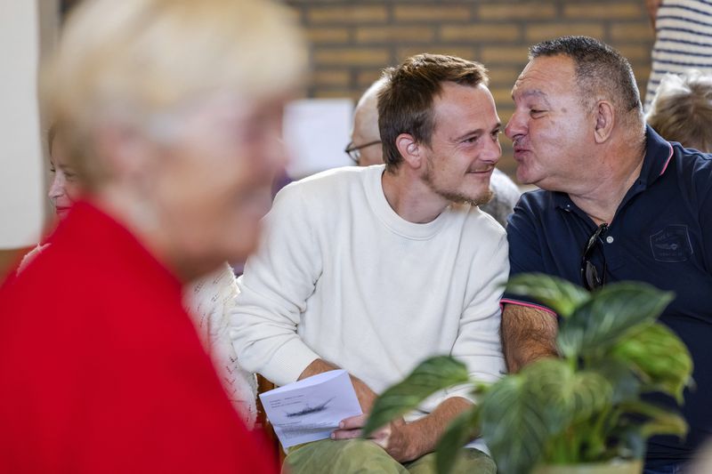 Parishioners show gratitude and connection during a service at the Don Bosco church in Buizingen, Belgium, Sunday, Sept. 8, 2024. (AP Photo/Geert Vanden Wijngaert)