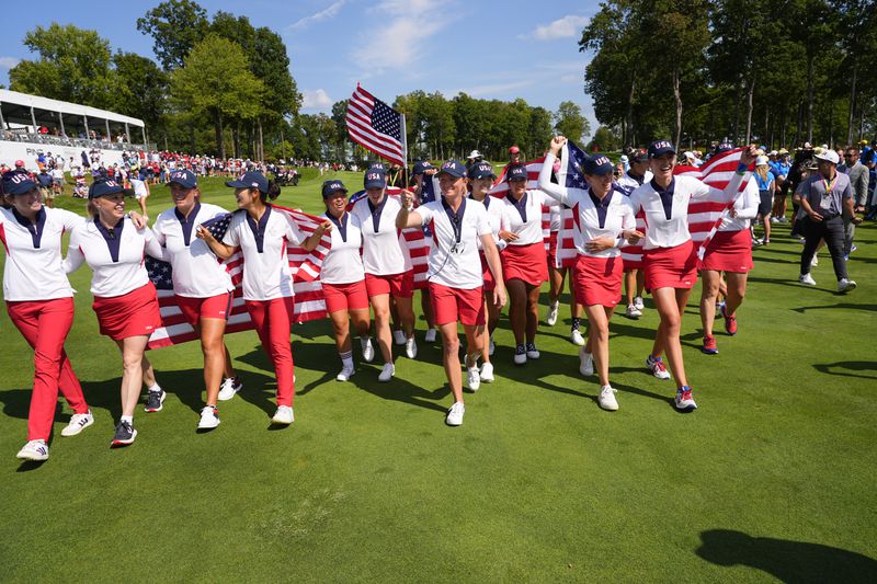 United States players celebrate after winning the Solheim Cup golf tournament against Europe at the Robert Trent Jones Golf Club, Sunday, Sept. 15, 2024, in Gainesville, Va. (AP Photo/Matt York)