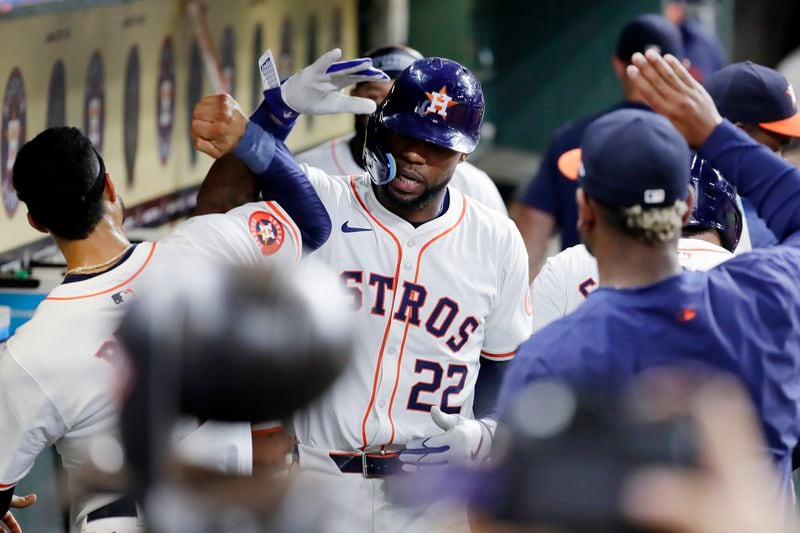 Houston Astros' Jason Heyward (22) collects high-fives in the dugout after his two-run home run against the Seattle Mariners during the fifth inning of a baseball game Tuesday, Sept. 24, 2024, in Houston. (AP Photo/Michael Wyke)