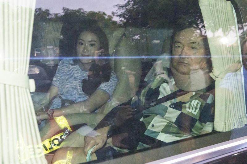 FILE - Former Thai Prime Minister Thaksin Shinawatra, right, sits in a vehicle with his daughter Paetongtarn in front of his residence after being released on parole, Sunday, Feb. 18, 2024, in Bangkok, Thailand. (AP Photo/Wason Wanichakorn File)