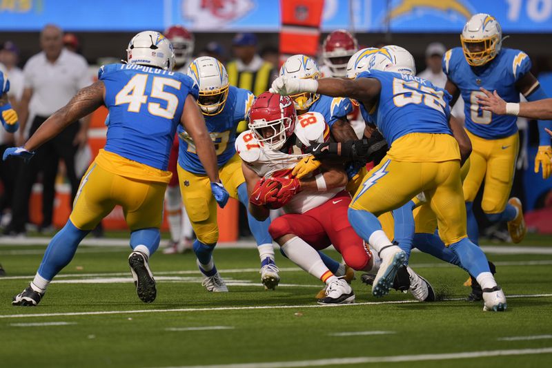 Kansas City Chiefs tight end Travis Kelce (87) catches a pass as a host of Los Angeles Chargers defend during the second half of an NFL football game Sunday, Sept. 29, 2024, in Inglewood, Calif. (AP Photo/Marcio Jose Sanchez)