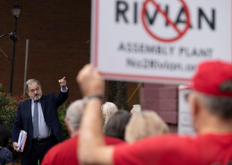 Citizens opposed to the measure gather outside to talk with their attorney, John Christy (left), after the Morgan County board of assessors voted to approve the Rivian tax exemption proposal in Madison on Wednesday, May 25, 2022.  (Bob Andres / robert.andres@ajc.com)
