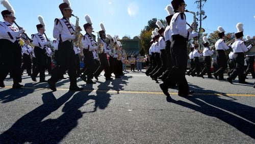 Lassiter High School Marching Band members march along Roswell Street during the 10th annual Marietta Veterans Day Parade at Roswell Street Baptist Church in Marietta on Tuesday, November 11, 2014.