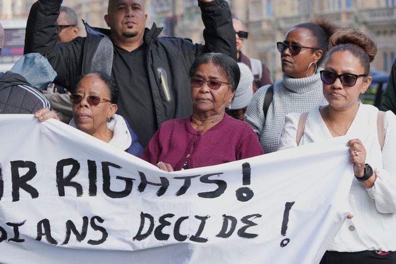 Chagossians Lucy Sagai, center, attends a protest to response the U.K. announcement to agree to hand sovereignty of the long-contested Chagos Islands to Mauritius and against their "Exclusion" from Chagos negotiations, outside the House of Parliament, in London, Monday, Oct. 7, 2024. (AP Photo/Kin Cheung)