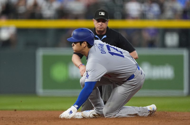 Los Angeles Dodgers' Shohei Ohtani steals second base in the second inning of a baseball game against the Colorado Rockies, Friday, Sept. 27, 2024, in Denver. (AP Photo/David Zalubowski)