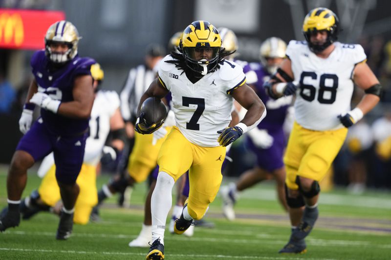 Michigan running back Donovan Edwards (7) runs for a touchdown against Washington during the first half of an NCAA college football game Saturday, Oct. 5, 2024, in Seattle. (AP Photo/Lindsey Wasson)