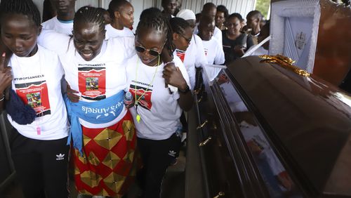 Relatives try to comfort a woman crying after viewing the body of Ugandan Olympic athlete Rebecca Cheptegei at Moi Teaching and Referral Hospital morgue in the western city of Eldoret, in Rift Valley, Kenya Friday, Sept. 13, 2024. (AP Photo/Andrew Kasuku)