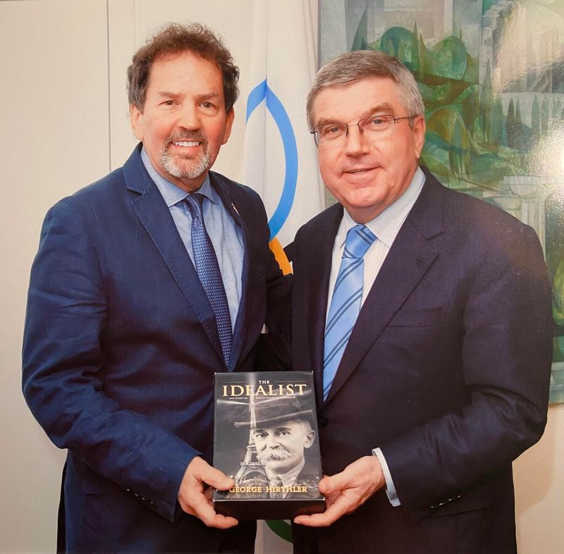 George Hirthler presents "The Idealist" to IOC President Thomas Bach in 2016.
