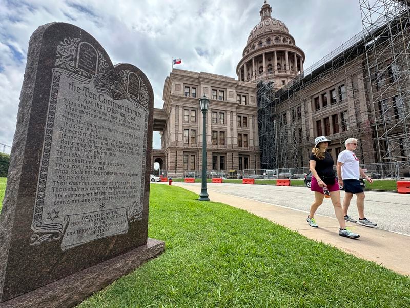 Construction workers walk past a monument of the Ten Commandments outside the Capitol, Thursday, June 20, 2024, in Austin, Texas. (AP Photo/Paul Weber)