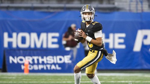 Carrollton quarterback Julian Lewis (10) drops back to pass during the first half against Mill Creek in the GHSA Class 7A finals, at Center Parc Stadium, Saturday, December 10, 2022, in Atlanta. Mill Creek defeated Carrollton 70-35. Carrollton freshman quarterback Julian Lewis threw for a state championship game record 531 yards and five touchdowns. (Jason Getz / Jason.Getz@ajc.com)