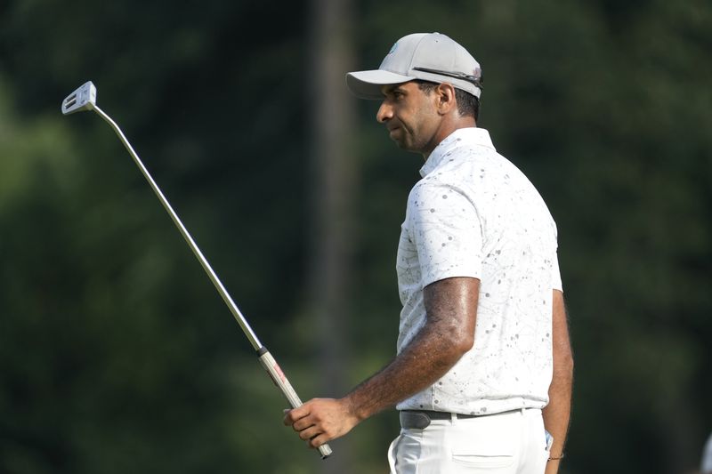 Aaron Rai, of England, reacts to his putt on the ninth hole during the final round of the Wyndham Championship golf tournament in Greensboro, N.C., Sunday, Aug. 11, 2024. (AP Photo/Chuck Burton)