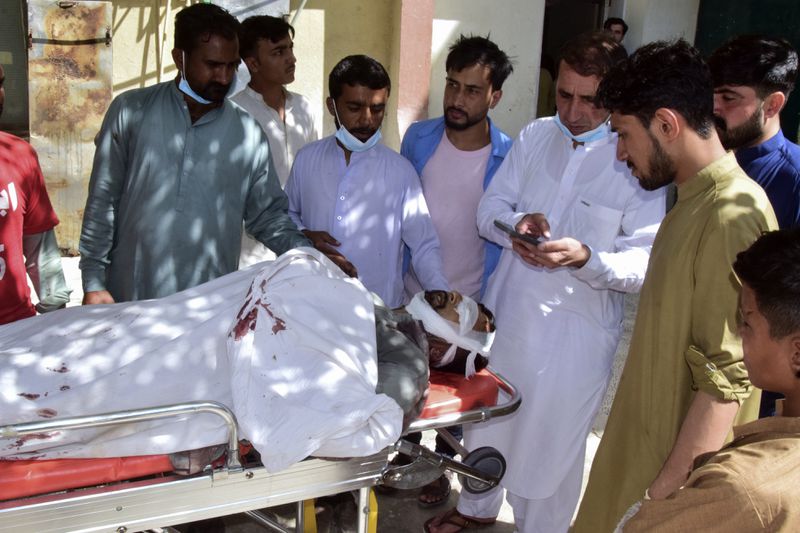 Relatives gather around a body of a passenger, killed by gunmen at a highway in Musakhail, as they wait for transportation at a hospital, in Quetta, Pakistan, Monday, Aug. 26, 2024. (AP Photo/Arshad Butt)