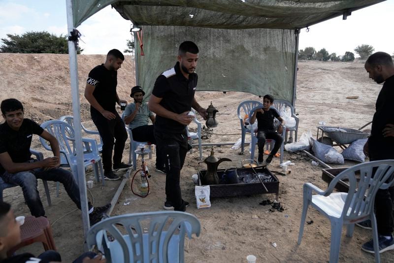 Relatives and friends of Qaid Farhan Alkadi, 52, who was held hostage by Hamas militants in Gaza Strip, wait for his arrival on an area in the Khirbet Karkur village, near Rahat, southern Israel, Wednesday, Aug. 28, 2024. (AP Photo/Mahmoud Illean)