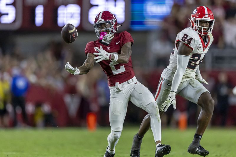 Alabama wide receiver Ryan Williams (2) makes a difficult bobbled catch with Georgia defensive back Malaki Starks (24) defending during the second half of an NCAA college football game, Saturday, Sept. 28, 2024, in Tuscaloosa, Ala. (AP Photo/Vasha Hunt)