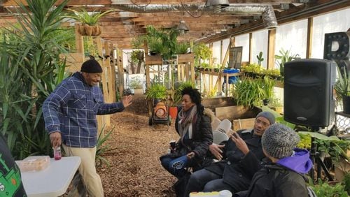 People talking at a Rid-All Rid-All Green Partnership agriculture facility in Cleveland.