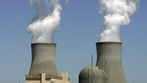 Steam rises from cooling towers at Georgia Power’s nuclear Plant Vogtle, in Waynesboro, Ga. The company is leading a massive plant expansion, which has gone billions of dollars over budget and is years delayed. Now the U.S. government is warning about the ramifications of a Florida utility’s attempts to drop out of the project. (AP Photo/Mary Ann Chastain, File)