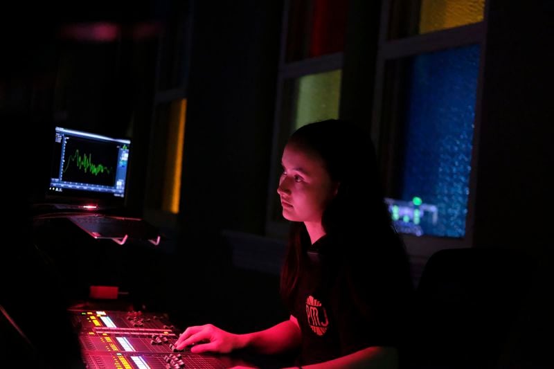 Sound engineer Amber Rhodes prepares before a concert at the Ryman Auditorium in Nashville, Tenn., on July 30, 2024. (AP Photo/Luis Andres Henao)