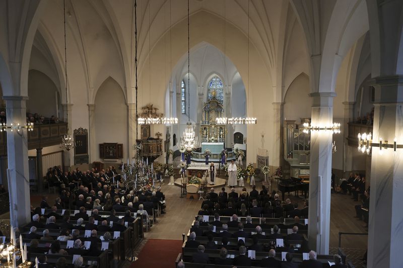 People attend the funeral service of Swedish soccer manager Sven-Goran Eriksson at Fryksände church in Torsby, Sweden, Friday Sept. 13, 2024. (Adam Ihse/TT News Agency via AP)