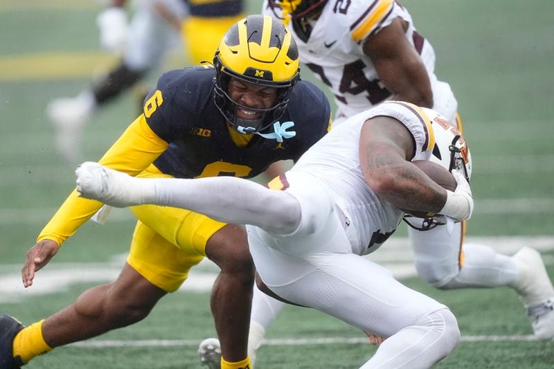 Michigan defensive back Brandyn Hillman (6) tackles Minnesota running back Darius Taylor (1) during the first half of an NCAA college football game, Saturday, Sept. 28, 2024, in Ann Arbor, Mich. (AP Photo/Carlos Osorio)