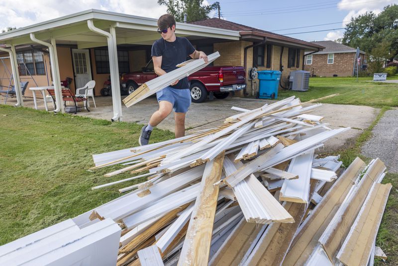 Gavin Hinchman with Precision One Construction Group carefully steps around water-damaged doors and walls as he guts part of a flooded home in Norco, La., on Friday, Sept. 13, 2024, two days after Hurricane Francine swept through the area. (Chris Granger/The Times-Picayune/The New Orleans Advocate via AP)