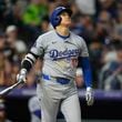 Los Angeles Dodgers' Shohei Ohtani watches the flight of his three-run home run off Colorado Rockies relief pitcher Anthony Molina in the sixth inning of a baseball game Friday, Sept. 27, 2024, in Denver. (AP Photo/David Zalubowski)