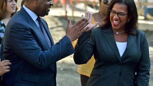 Mayor Kasim Reed gets a high five from Atlanta Watershed Commissioner Kishia L. Powell during ceremony to kick of the drilling of a tunnel used to create a reservoir that will give Atlanta a 60-day reserve water supply. A $11.6 million tunnel-boring machine, measuring over 400 feet long will dig a 5 mile tunnel to connect the quarry to the Chattahoochee River. The massive tunnel boring machine was officially named “Driller Mike” after Atlanta rapper and small business owner Driller Mike. BRANT SANDERLIN/BSANDERLIN@AJC.COM