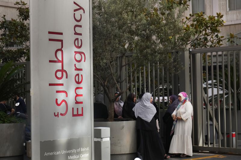 Families of victims who were injured on Monday by their exploding handheld pagers, wait at the emergency entrance of the American University hospital, in Beirut, Lebanon, Wednesday, Sept. 18, 2024. (AP Photo/Hussein Malla)