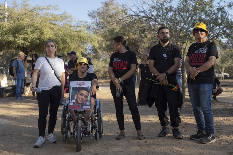 Mourners attend the funeral of Avraham Munder, who was killed in Hamas captivity in the Gaza Strip and recovered by the Israeli military in Gaza, at Kibbutz Nir Oz, southern Israel, Wednesday, Aug. 21, 2024. On Tuesday, the Israeli military said its forces recovered six bodies of hostages kidnapped on Oct. 7 in an overnight operation in southern Gaza. (AP Photo/Ohad Zwigenberg)