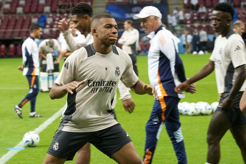 Real Madrid's Kylian Mbappe attends a training session ahead of the UEFA Super Cup Final soccer match between Real Madrid and Atalanta at the Narodowy stadium in Warsaw, Poland, Tuesday, Aug. 13, 2024. (AP Photo/Czarek Sokolowski)