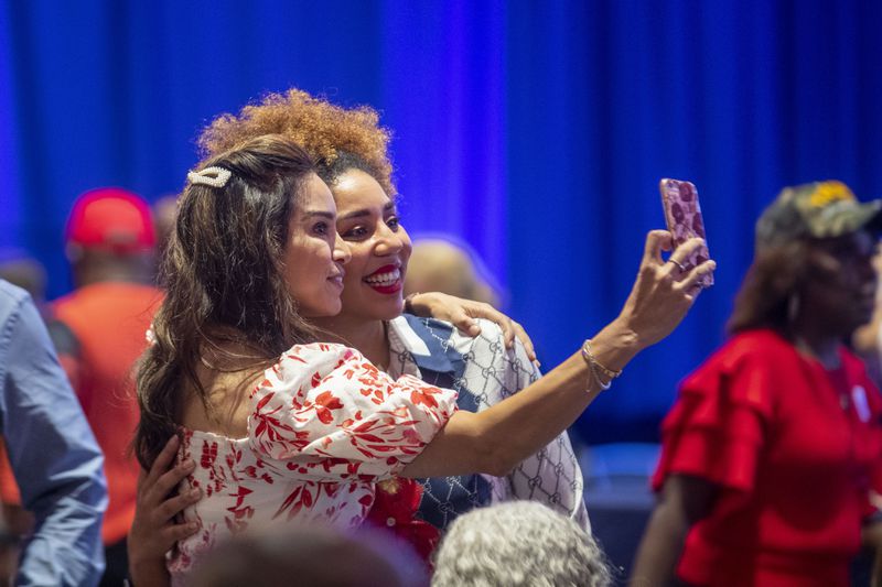 09/25/2020 - Atlanta, Georgia - Members of the crowd take selfies, sans masks, before the start of the Blacks for Trump campaign rally at the Cobb Galleria Centre in Atlanta, Friday, September 25, 2020.  (Alyssa Pointer / Alyssa.Pointer@ajc.com)