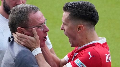 Austria's Christoph Baumgartner celebrates with Austria's head coach Ralf Rangnick after scoring his side's second goal during a Group D match between Poland and Austria at the Euro 2024 soccer tournament in Berlin, Germany, Friday, June 21, 2024. (AP Photo/Petr Josek)