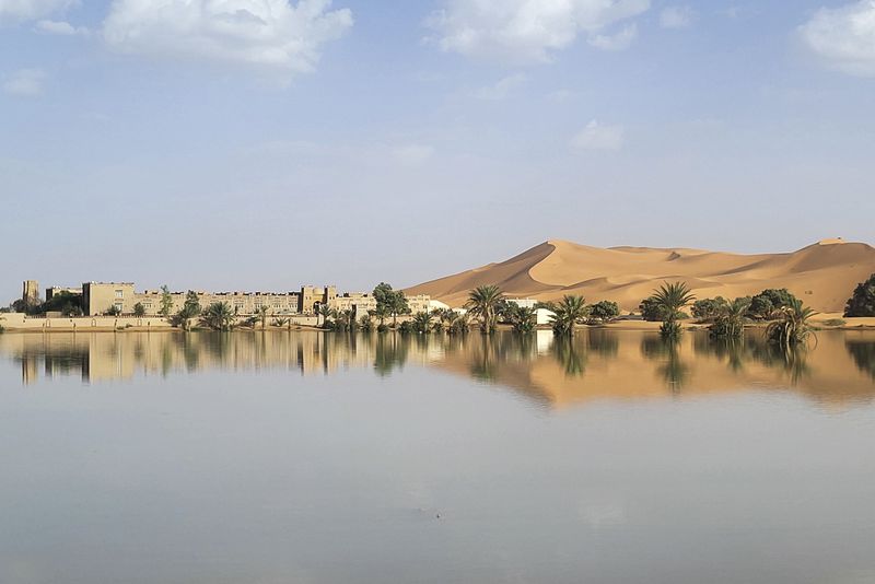 An oasis is reflected in a lake caused by heavy rainfall in the desert town of Merzouga, near Rachidia, southeastern Morocco, Wednesday, Oct. 2, 2024. (AP Photo)