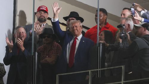 Former President Donald Trump waves to fans during the first half of the football game between Alabama and Georgia at Bryant-Denny Stadium, Saturday, Sept. 28, 2024, in Tuscaloosa, Al. (Jason Getz / AJC)

