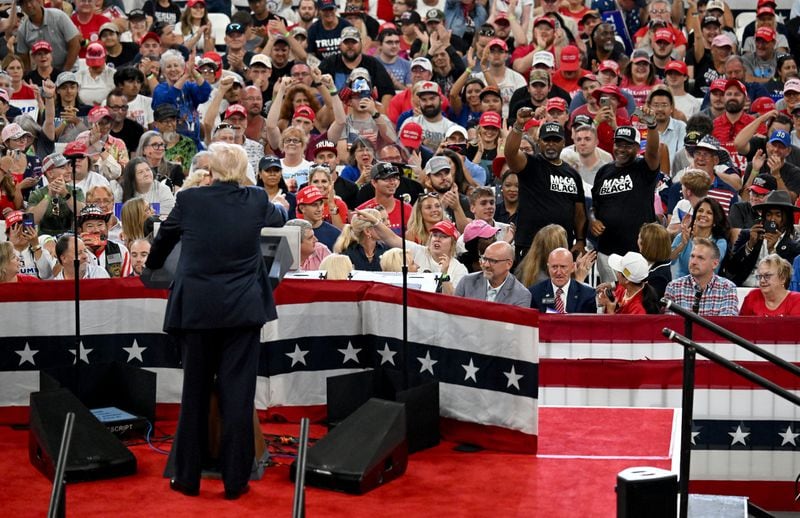 Two MEGA Black supporters are recognized by former President Donald Trump during a rally at the Georgia State University’s convocation center on Saturday, August 3, 2024 in Atlanta. Former President Donald Trump and Vice-Presidential candidate JD Vance are holding their first rally together in Georgia on Saturday at the same place – the GSU Convocation Center- Kamala Harris held hers earlier this week.  (Hyosub Shin / AJC)