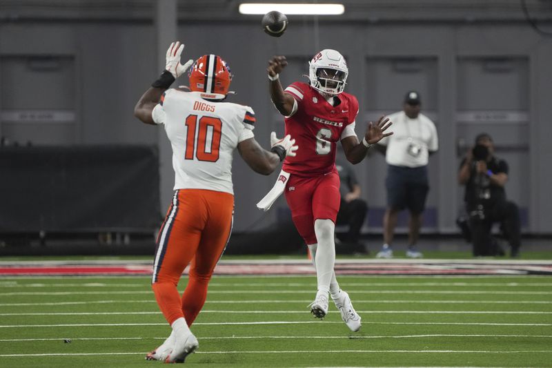 UNLV quarterback Hajj-Malik Williams, right, throws over Syracuse defensive lineman Fadil Diggs (10) in the first half during an NCAA college football game, Friday, Oct. 4, 2024, in Las Vegas. (AP Photo/Rick Scuteri)