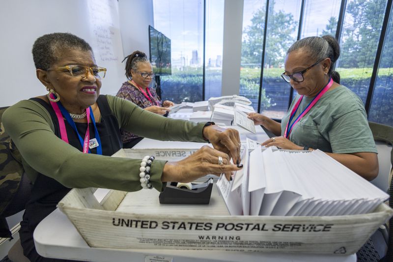 left to right; Carol Hamilton, Cristo Carter and Cynthia Huntley prepare ballots to be mailed at the Mecklenburg County Board of Elections in Charlotte, N.C., Thursday, Sept. 5, 2024. (AP Photo/Nell Redmond)